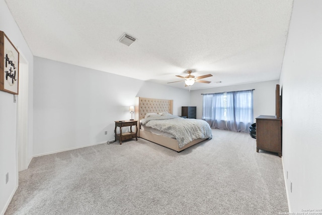carpeted bedroom with ceiling fan and baseboards