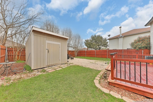 view of yard with a storage unit, an outbuilding, and a deck