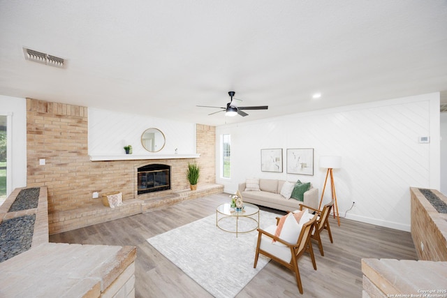 15031 Geronimo, San Antonio, TX 78254 - living area with wood finished floors, a brick fireplace, ceiling fan, and baseboards