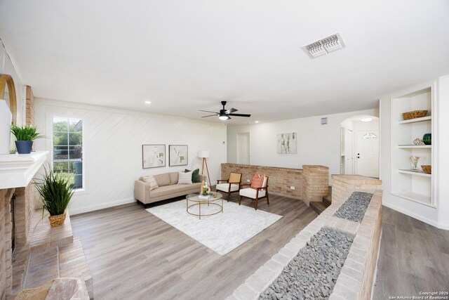 15031 Geronimo, San Antonio, TX 78254 - living room with arched walkways, ceiling fan, wood finished floors, baseboards, and built in features