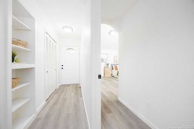 15031 Geronimo, San Antonio, TX 78254 - hall with light wood-style flooring, baseboards, built in features, and arched walkways