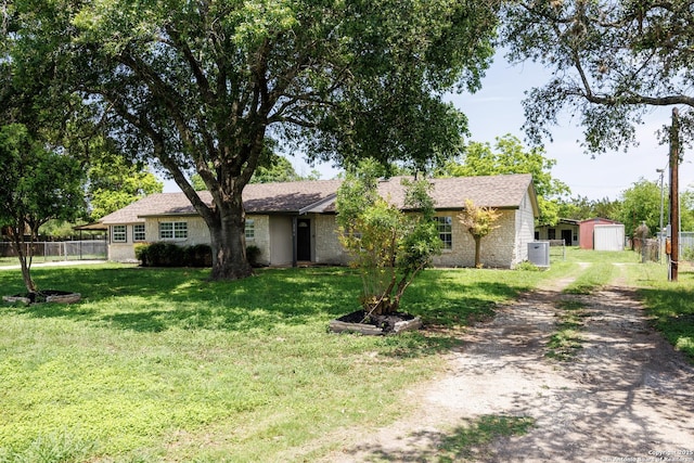 15031 Geronimo, San Antonio, TX 78254 - ranch-style house with dirt driveway, brick siding, a storage shed, and an outdoor structure