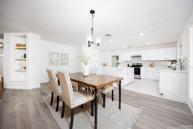 15031 Geronimo, San Antonio, TX 78254 - dining room featuring a chandelier, light wood-style flooring, and recessed lighting