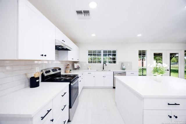 15031 Geronimo, San Antonio, TX 78254 - kitchen with appliances with stainless steel finishes, a sink, under cabinet range hood, light countertops, and backsplash