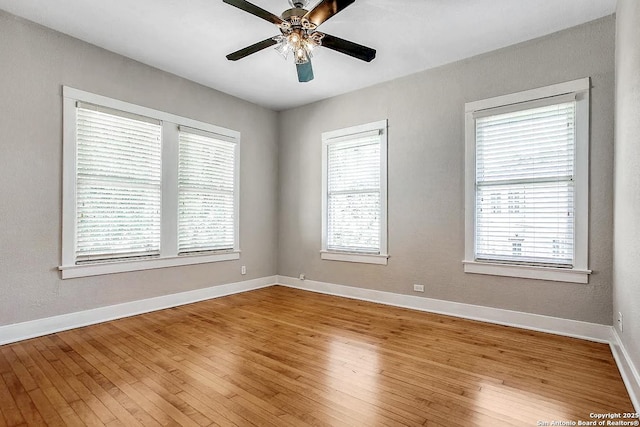 empty room with light wood-type flooring, baseboards, and ceiling fan
