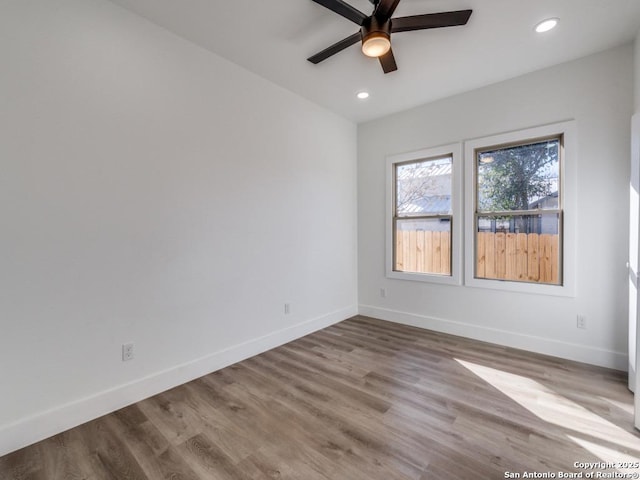 spare room featuring ceiling fan, baseboards, recessed lighting, and wood finished floors