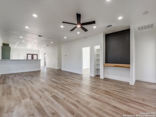 unfurnished living room with recessed lighting, a ceiling fan, light wood-style flooring, and baseboards