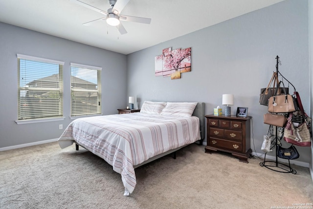 bedroom with carpet flooring, baseboards, and a ceiling fan