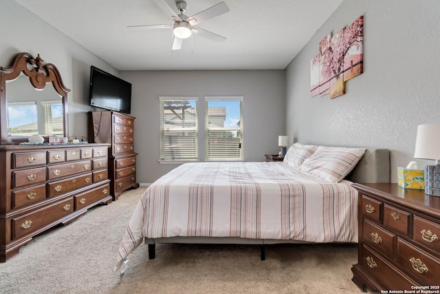 bedroom with light colored carpet and ceiling fan