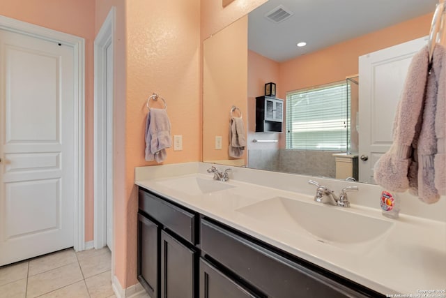 bathroom with tile patterned floors and double vanity
