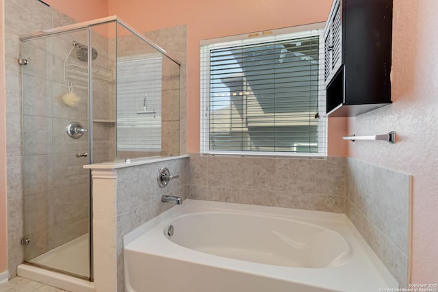 full bathroom featuring a shower stall and a garden tub