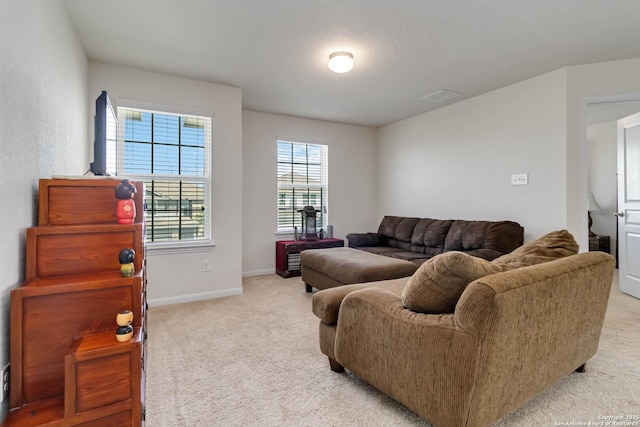 living area with light carpet and baseboards