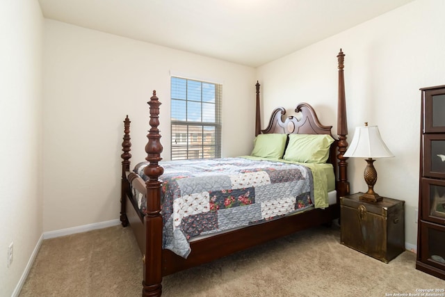bedroom with light colored carpet and baseboards