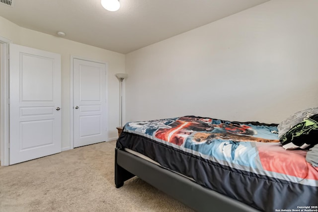 bedroom featuring light carpet