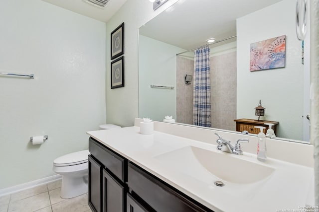 bathroom featuring tile patterned floors, toilet, a tile shower, vanity, and baseboards