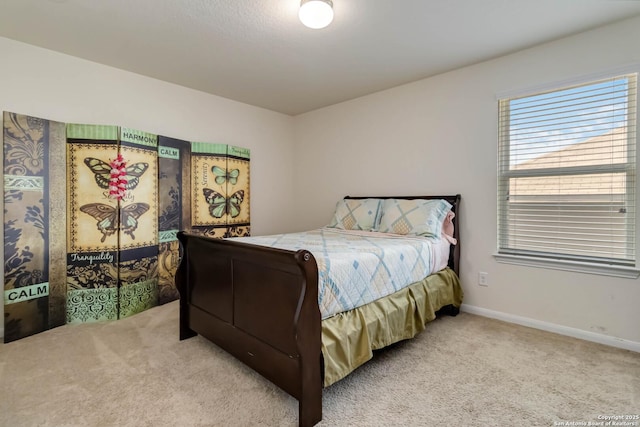 bedroom with carpet flooring and baseboards