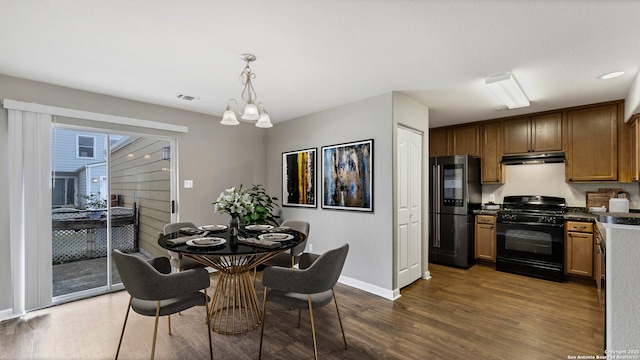 220 Trestle Tree Unit 112, San Marcos, TX 78666 - dining room featuring baseboards, dark wood-style floors, and a chandelier