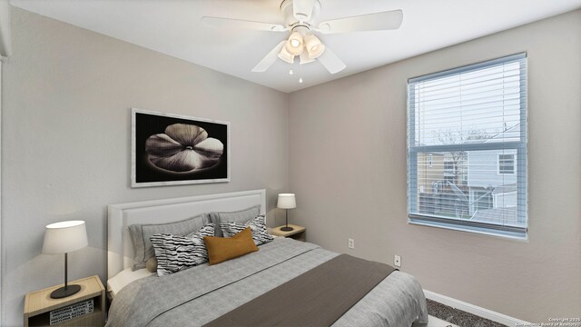 220 Trestle Tree Unit 112, San Marcos, TX 78666 - bedroom featuring baseboards, carpet flooring, and ceiling fan