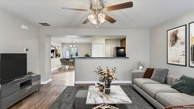 220 Trestle Tree Unit 112, San Marcos, TX 78666 - living area featuring dark wood-style flooring, a chandelier, a ceiling fan, and baseboards