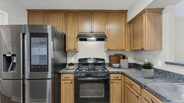 220 Trestle Tree Unit 112, San Marcos, TX 78666 - kitchen featuring stainless steel fridge, black gas stove, under cabinet range hood, brown cabinets, and a sink