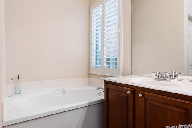 bathroom with healthy amount of natural light, vanity, and a garden tub