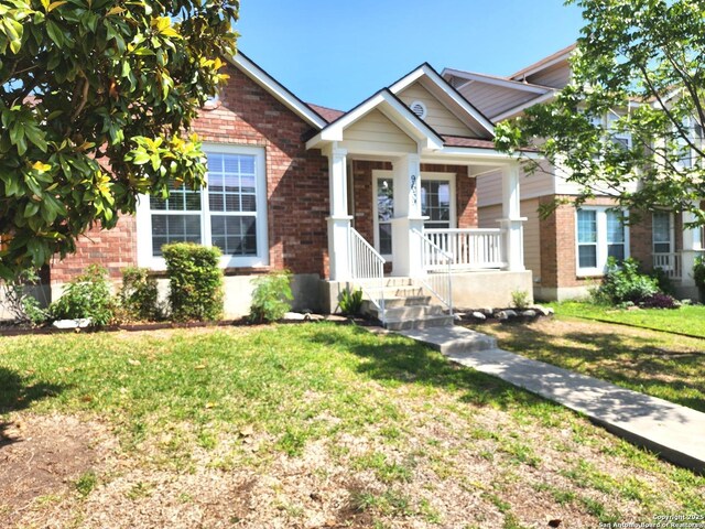 9639 Wild Horse, San Antonio, TX 78251 - view of front facade featuring brick siding, a front yard, and covered porch