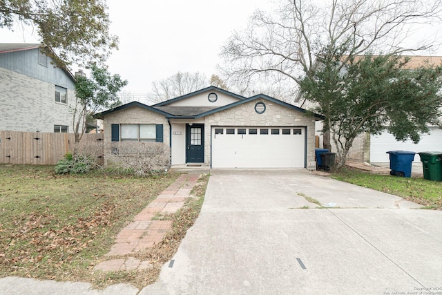 ranch-style house featuring a garage, concrete driveway, and fence