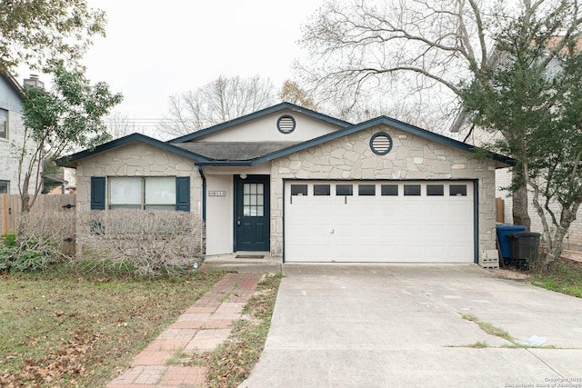 single story home with stone siding, a garage, driveway, and fence