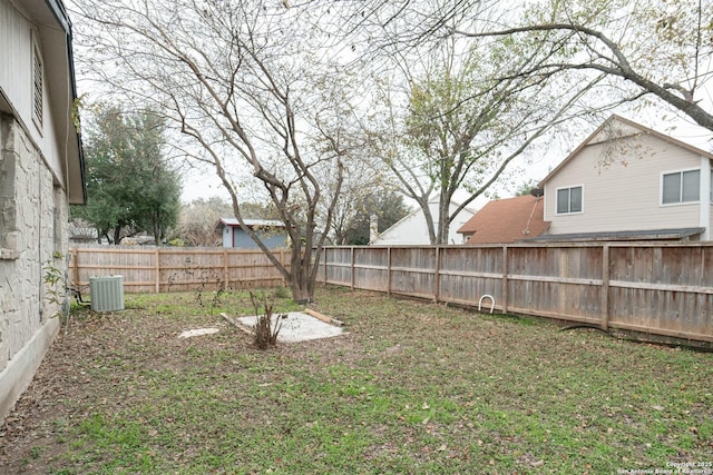 fenced backyard featuring central AC unit