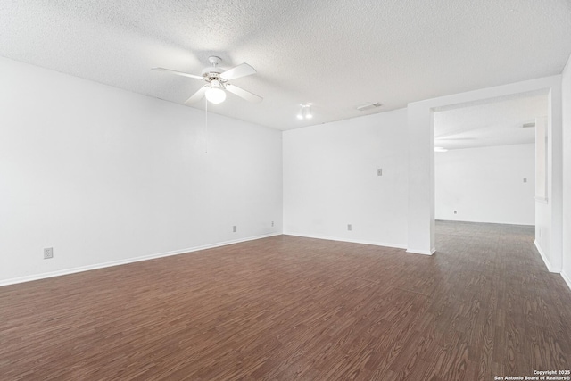 unfurnished room featuring dark wood-style floors, a textured ceiling, a ceiling fan, and baseboards