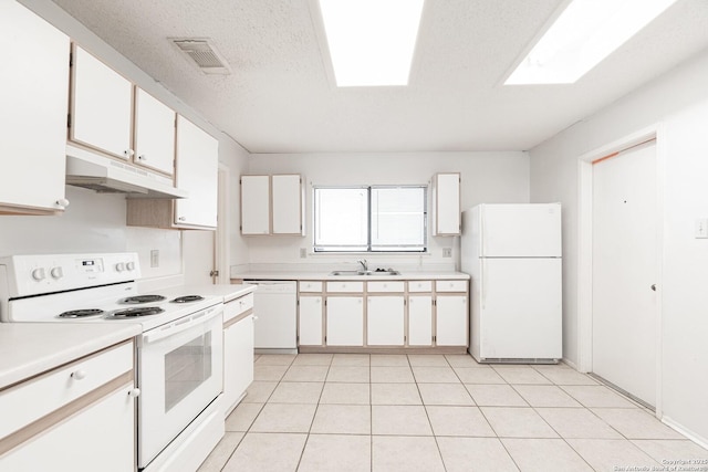 kitchen featuring white appliances, under cabinet range hood, a sink, light countertops, and a textured ceiling