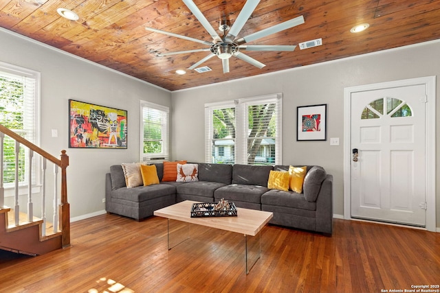 living area featuring wood ceiling, baseboards, ceiling fan, wood finished floors, and stairway