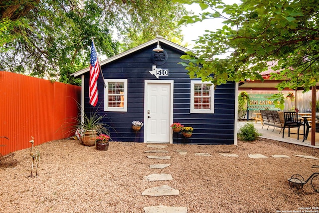 view of outbuilding with fence and an outdoor structure