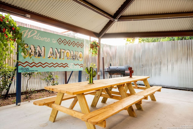 view of patio with outdoor dining space and fence