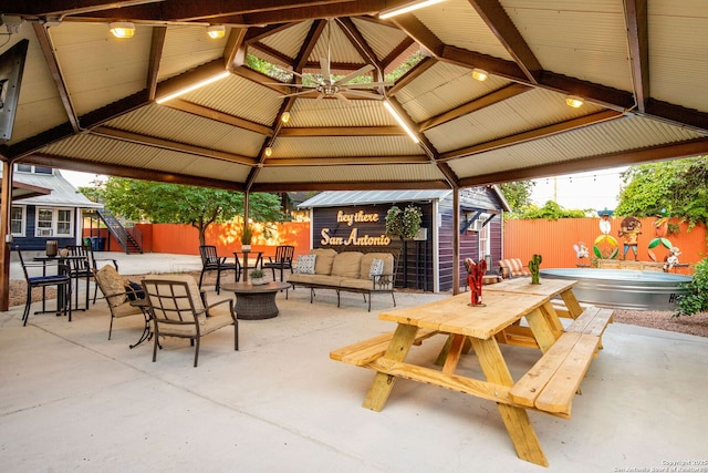 view of patio / terrace with a gazebo, a shed, outdoor dining area, and a fenced backyard