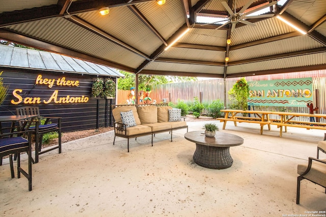 view of patio / terrace with a gazebo, fence, and a ceiling fan