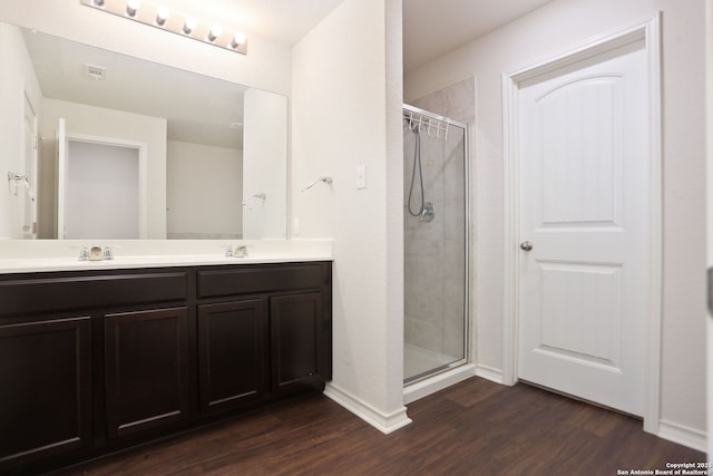 13340 Hackney Pony, San Antonio, TX 78254 - bathroom with wood finished floors, a shower stall, double vanity, and baseboards
