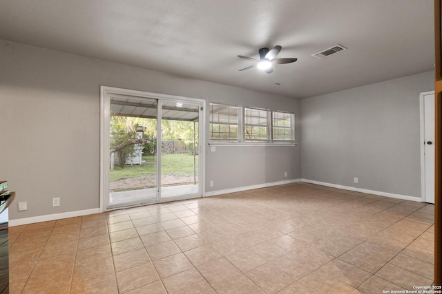 spare room with ceiling fan, baseboards, and light tile patterned flooring