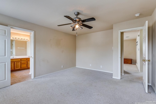 9007 Burnt Peak, Helotes, TX 78023 - unfurnished bedroom featuring light colored carpet, baseboards, ensuite bathroom, and ceiling fan