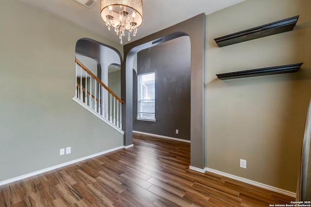 9007 Burnt Peak, Helotes, TX 78023 - entrance foyer featuring arched walkways, baseboards, wood finished floors, a chandelier, and stairs