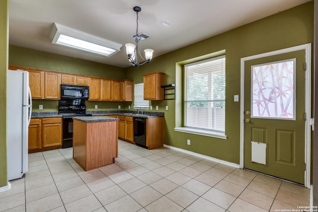9007 Burnt Peak, Helotes, TX 78023 - kitchen with black appliances, a kitchen island, dark countertops, a chandelier, and hanging light fixtures