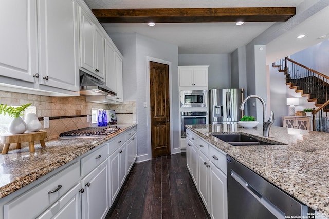 8826 Falcon Pl, San Antonio, TX 78256 - kitchen featuring appliances with stainless steel finishes, a sink, under cabinet range hood, beamed ceiling, and white cabinetry