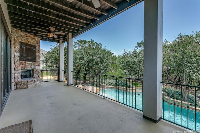 8826 Falcon Pl, San Antonio, TX 78256 - balcony featuring an outdoor stone fireplace, ceiling fan, view of pool area, and a patio area