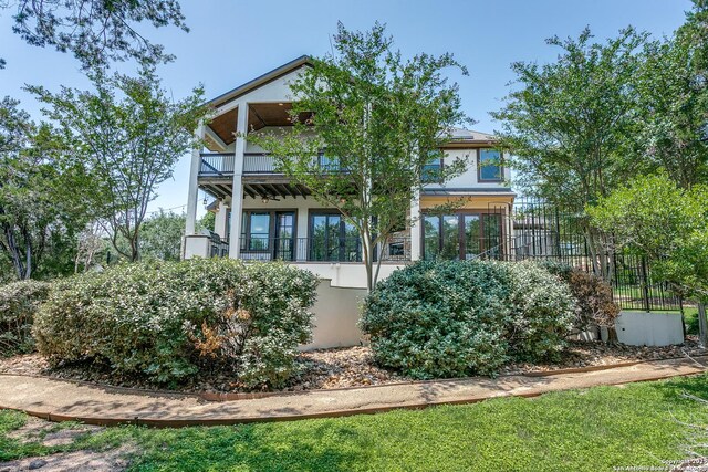 8826 Falcon Pl, San Antonio, TX 78256 - back of house with a balcony, stucco siding, and fence