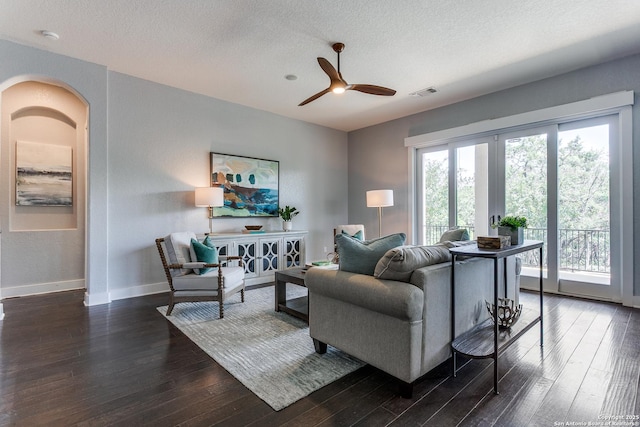 8826 Falcon Pl, San Antonio, TX 78256 - living room with dark wood-style flooring, a ceiling fan, baseboards, and a textured ceiling