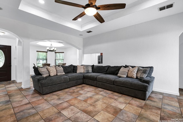 living area featuring a chandelier, arched walkways, baseboards, ceiling fan, and ornamental molding