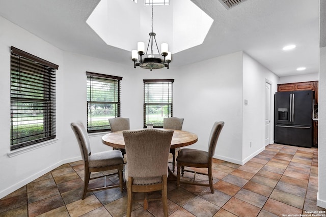 dining space featuring baseboards, a chandelier, and recessed lighting