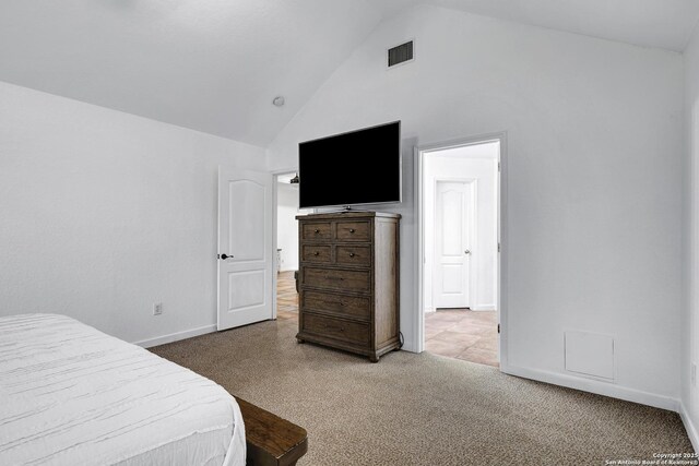 carpeted bedroom featuring high vaulted ceiling and baseboards