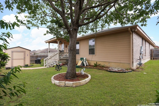 rear view of house featuring a storage unit and an outdoor structure