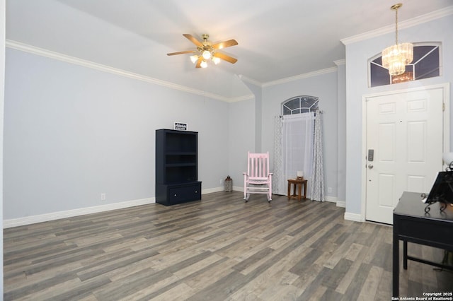 sitting room featuring ceiling fan, a chandelier, baseboards, ornamental molding, and wood finished floors